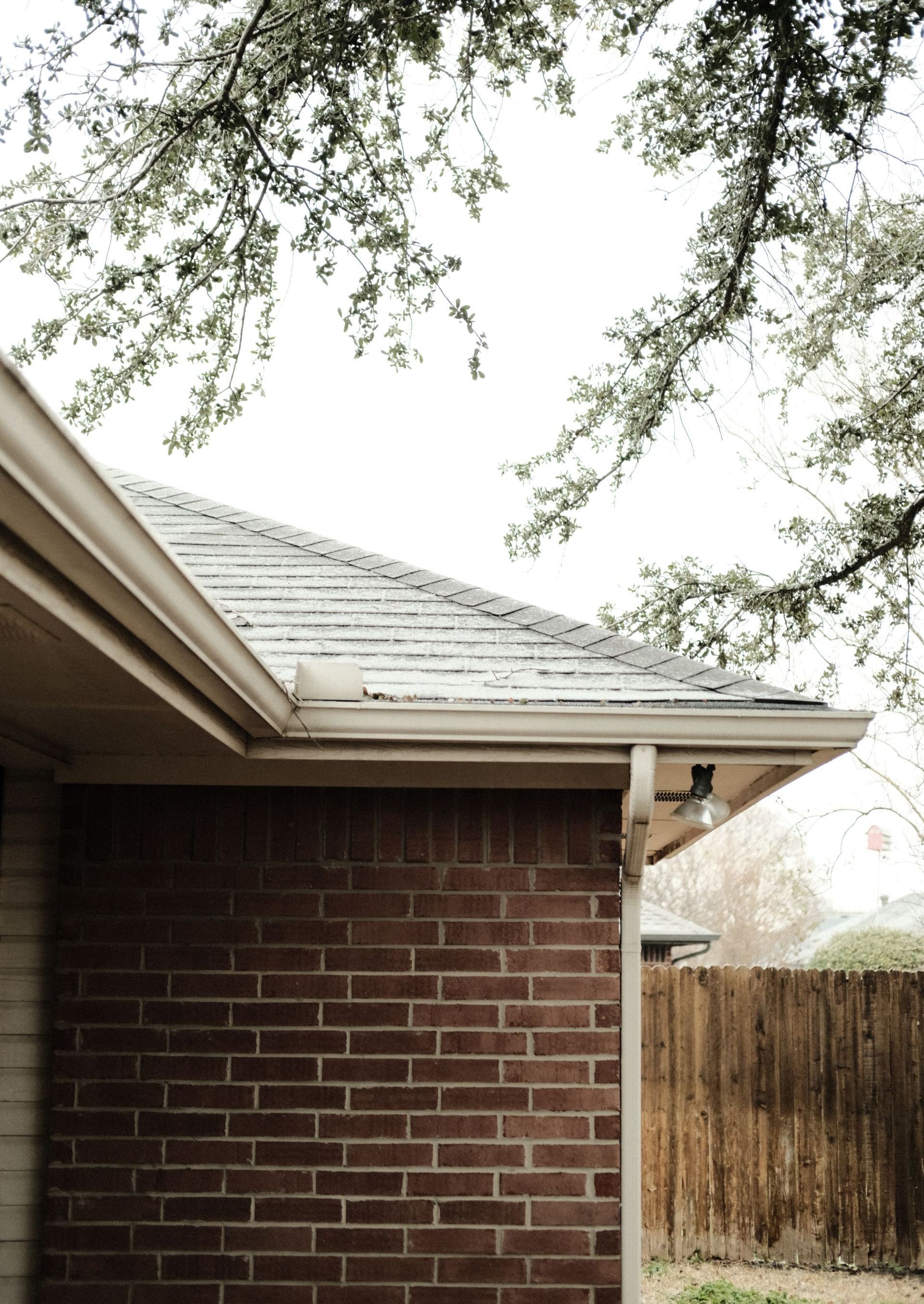 a brick house with a gutter on the side of it