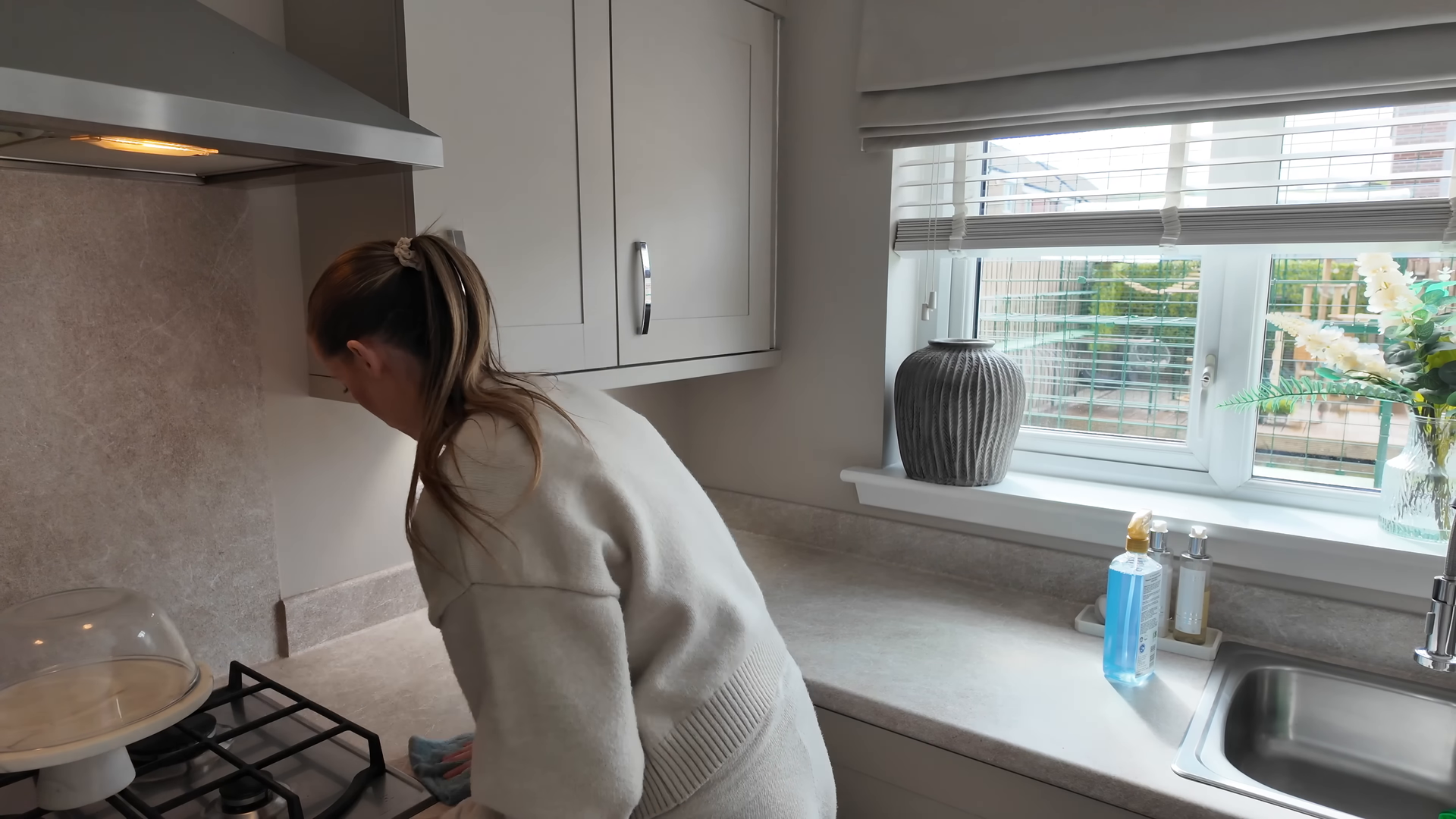 Cleaner preparing a guest-ready short-term rental apartment