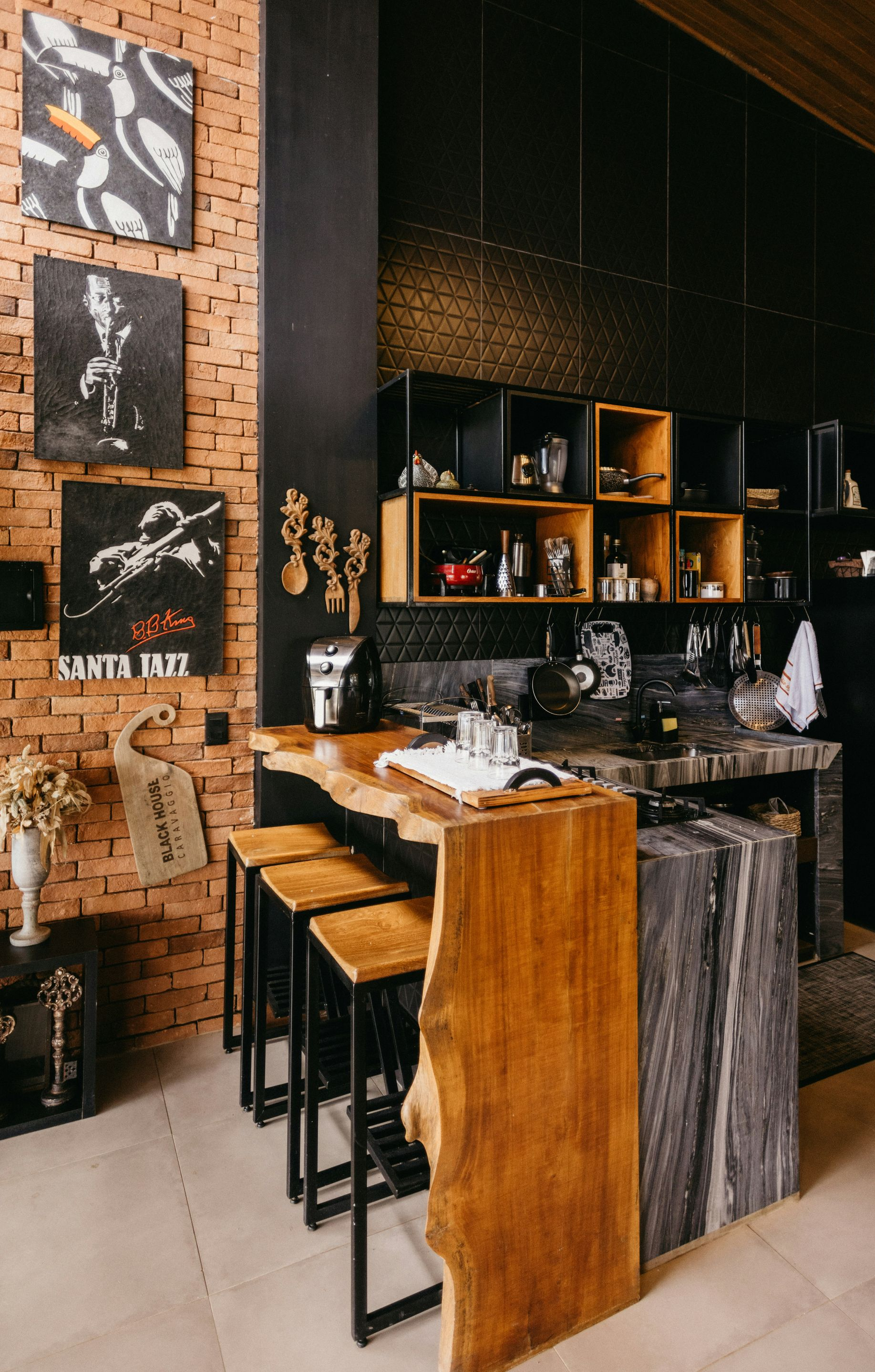 Cozy brick cafe bar with wooden stools, open shelves, and warm ambient lighting