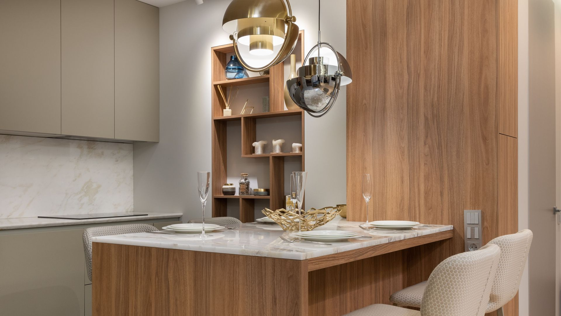 Modern kitchen with wood island, marble countertop, open shelving, and metallic pendant lights