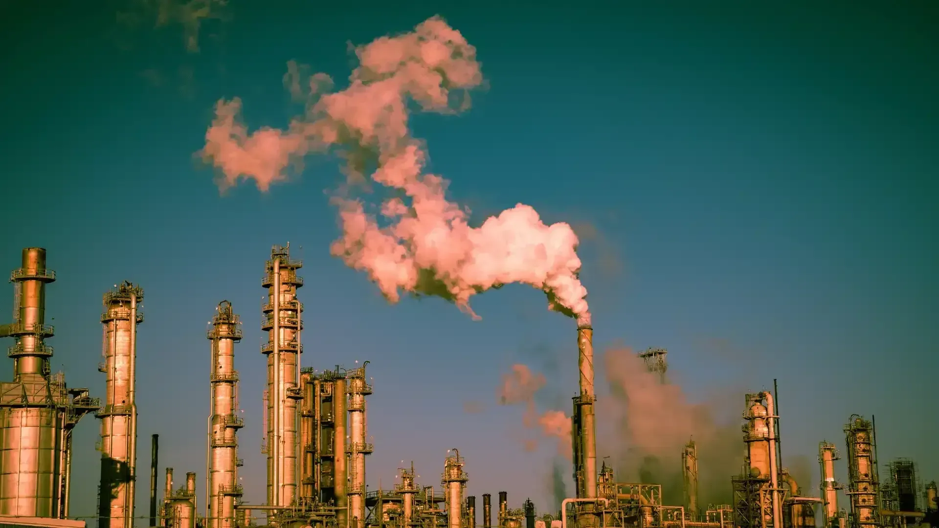A factory with smoke coming out of the chimneys