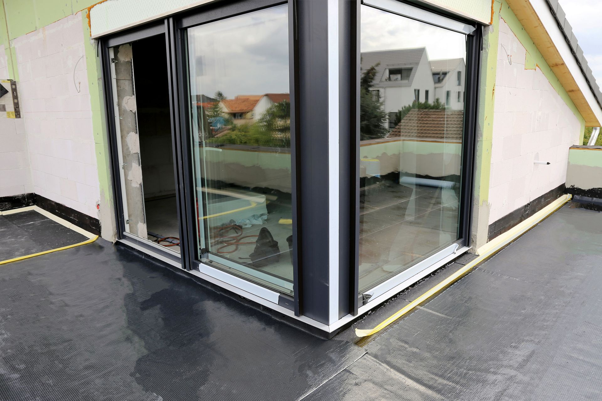 A building under construction with a lot of windows and a sliding glass door.