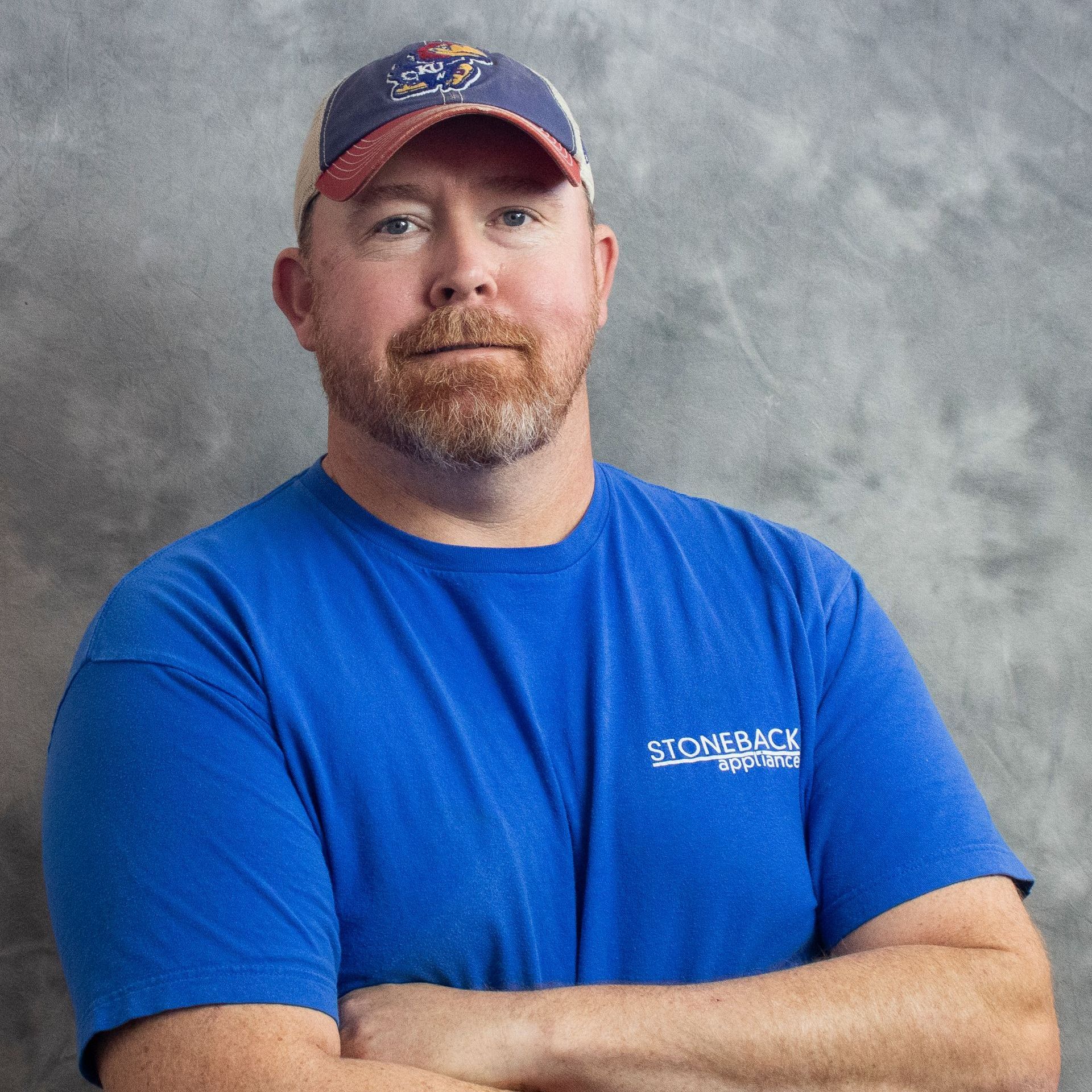 A man wearing a blue shirt that says stone & ice
