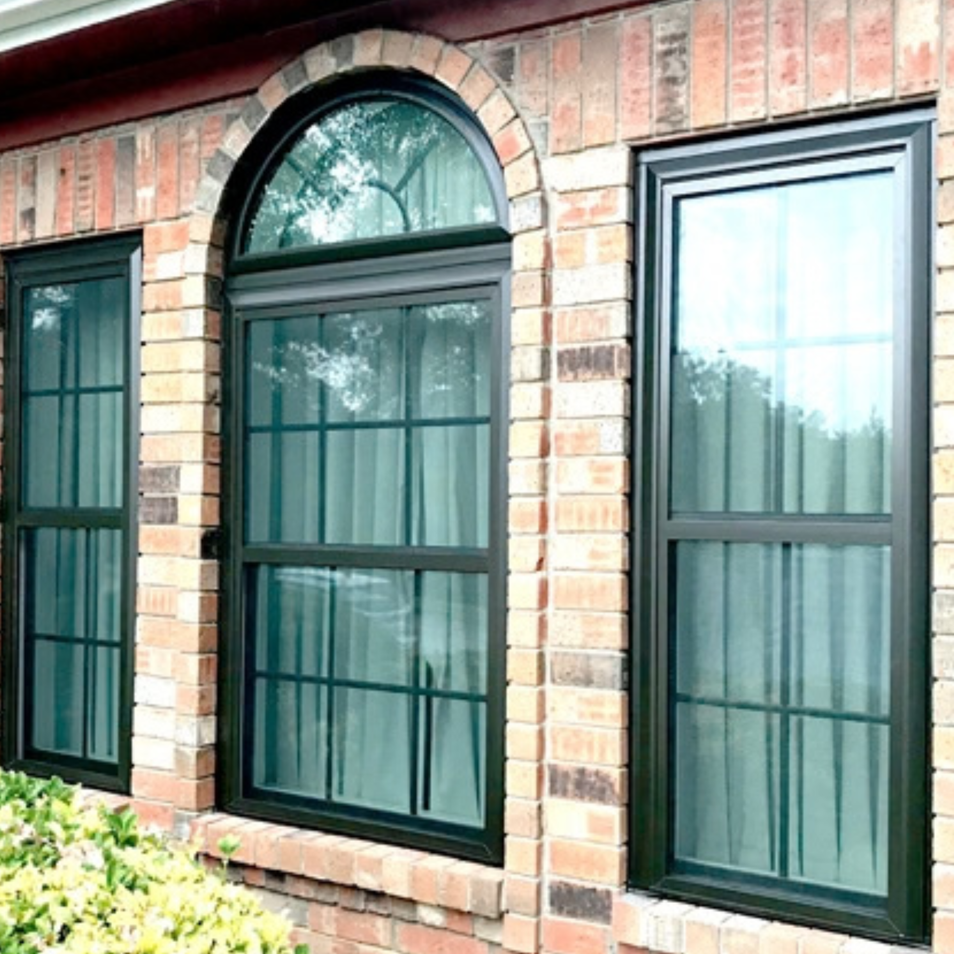 Newly installed replacement windows on a brick home