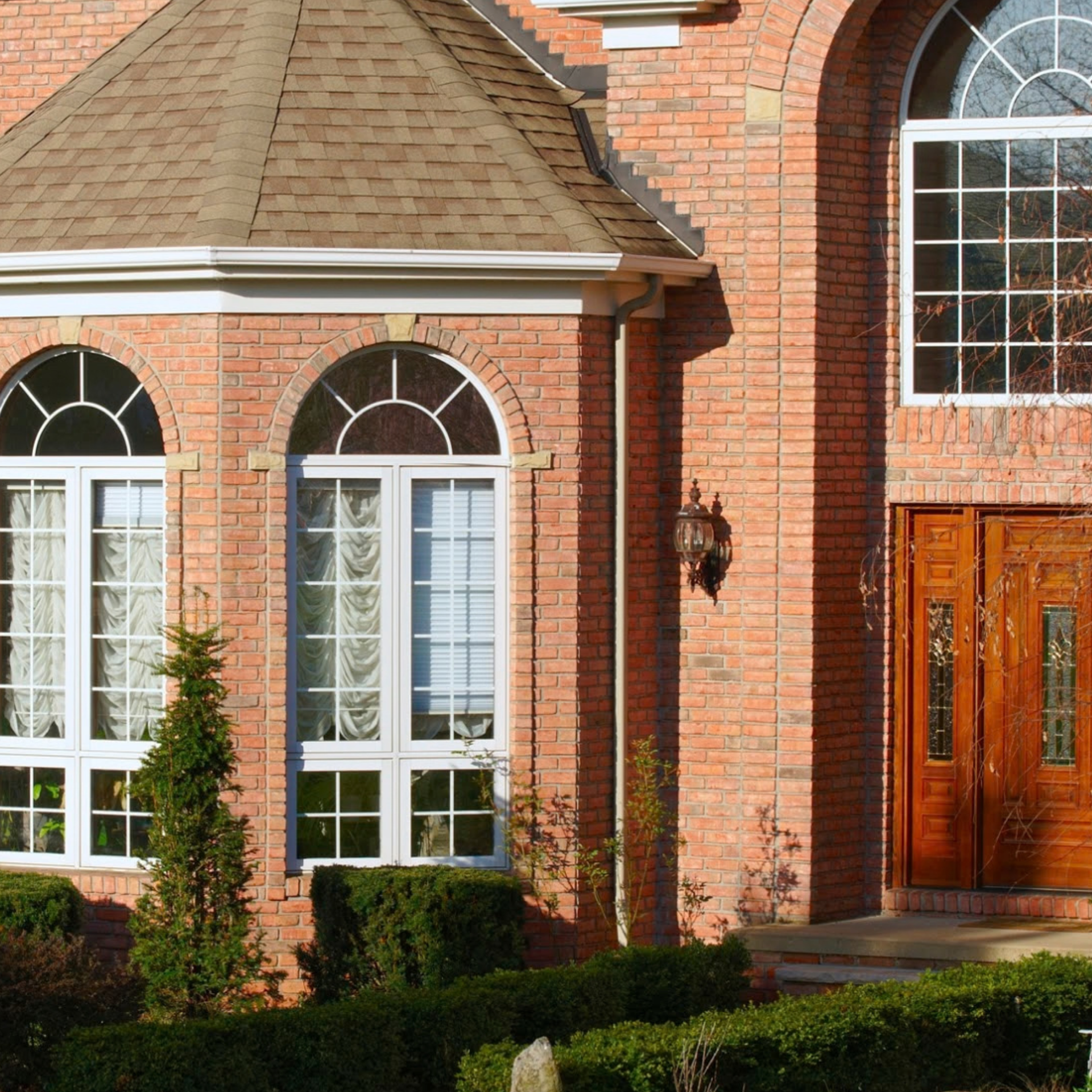 Custom white double-hung replacement windows on residential home