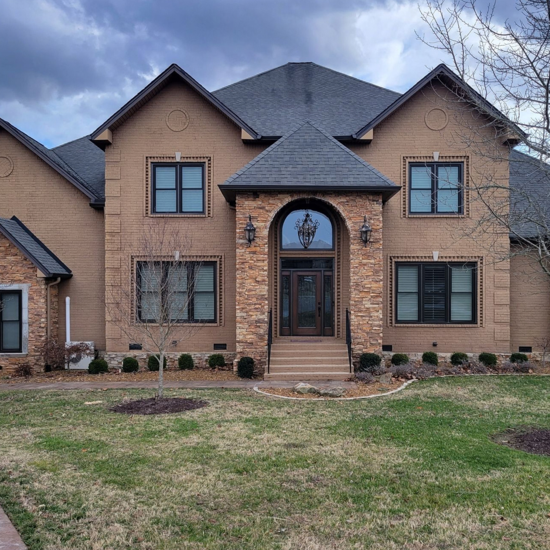 Newly installed replacement windows on a brick home