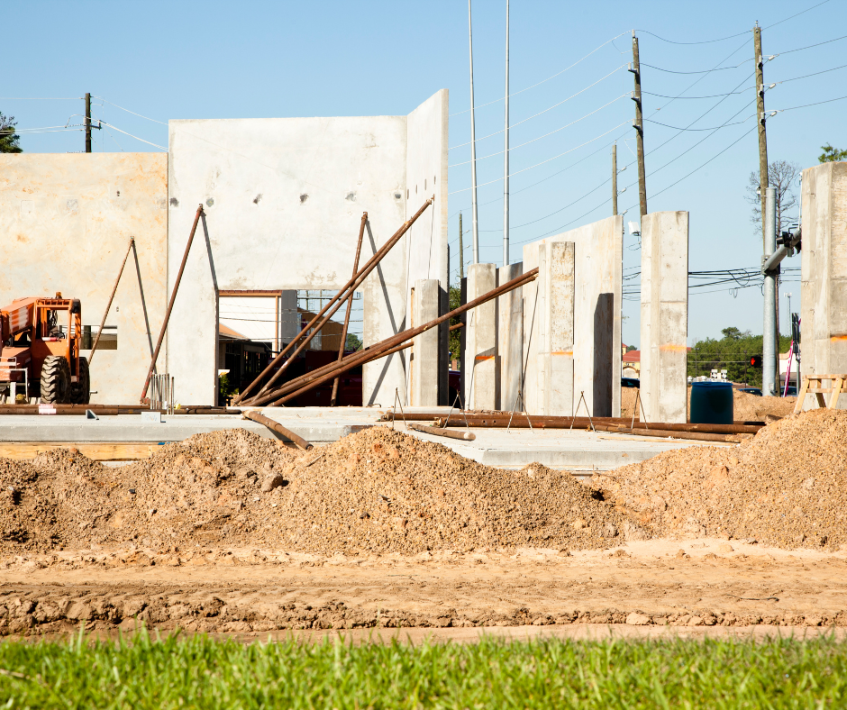 A construction site with a lot of dirt and concrete