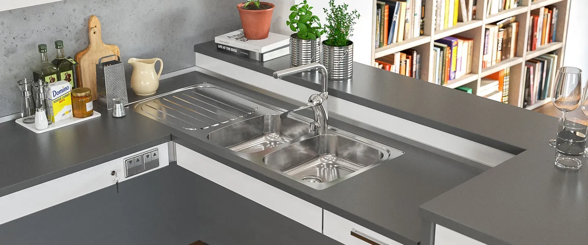 A kitchen with a sink and a bookshelf in the background.