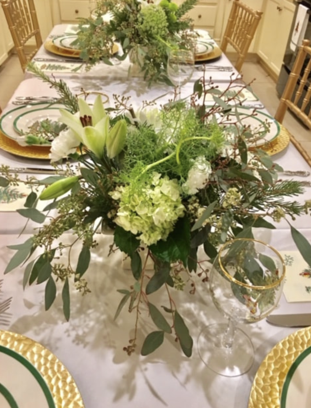 A table with plates and a vase of flowers on it