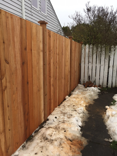 A house with a wooden fence in front of it