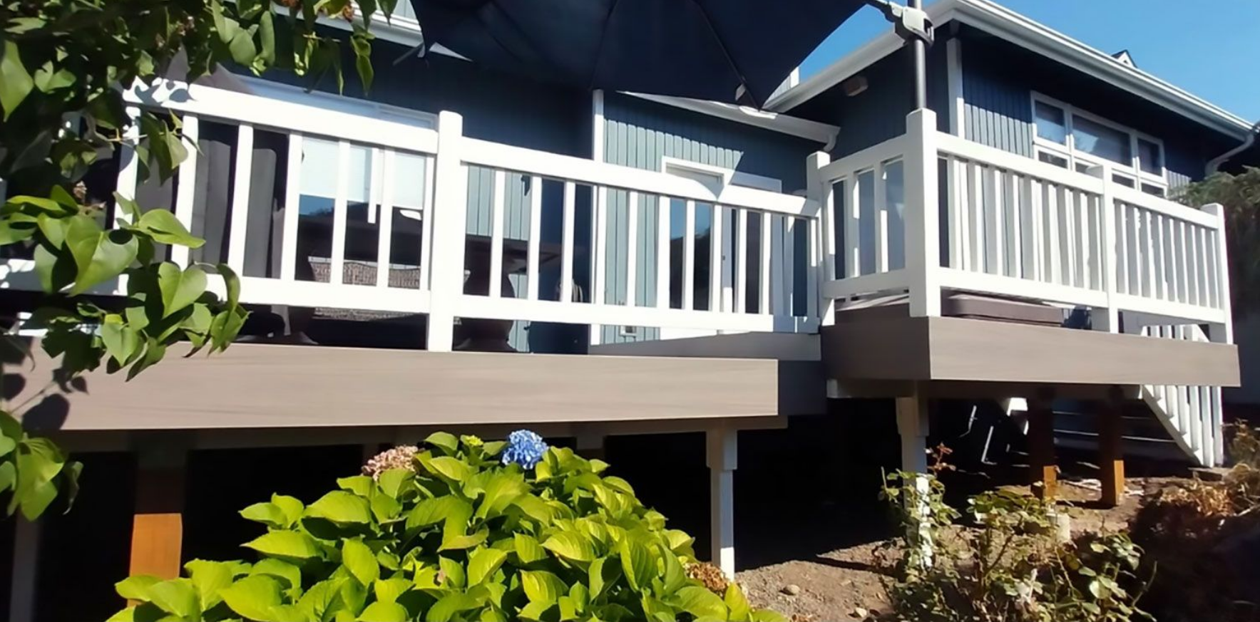 There is a pergola with a couch underneath it in the backyard.