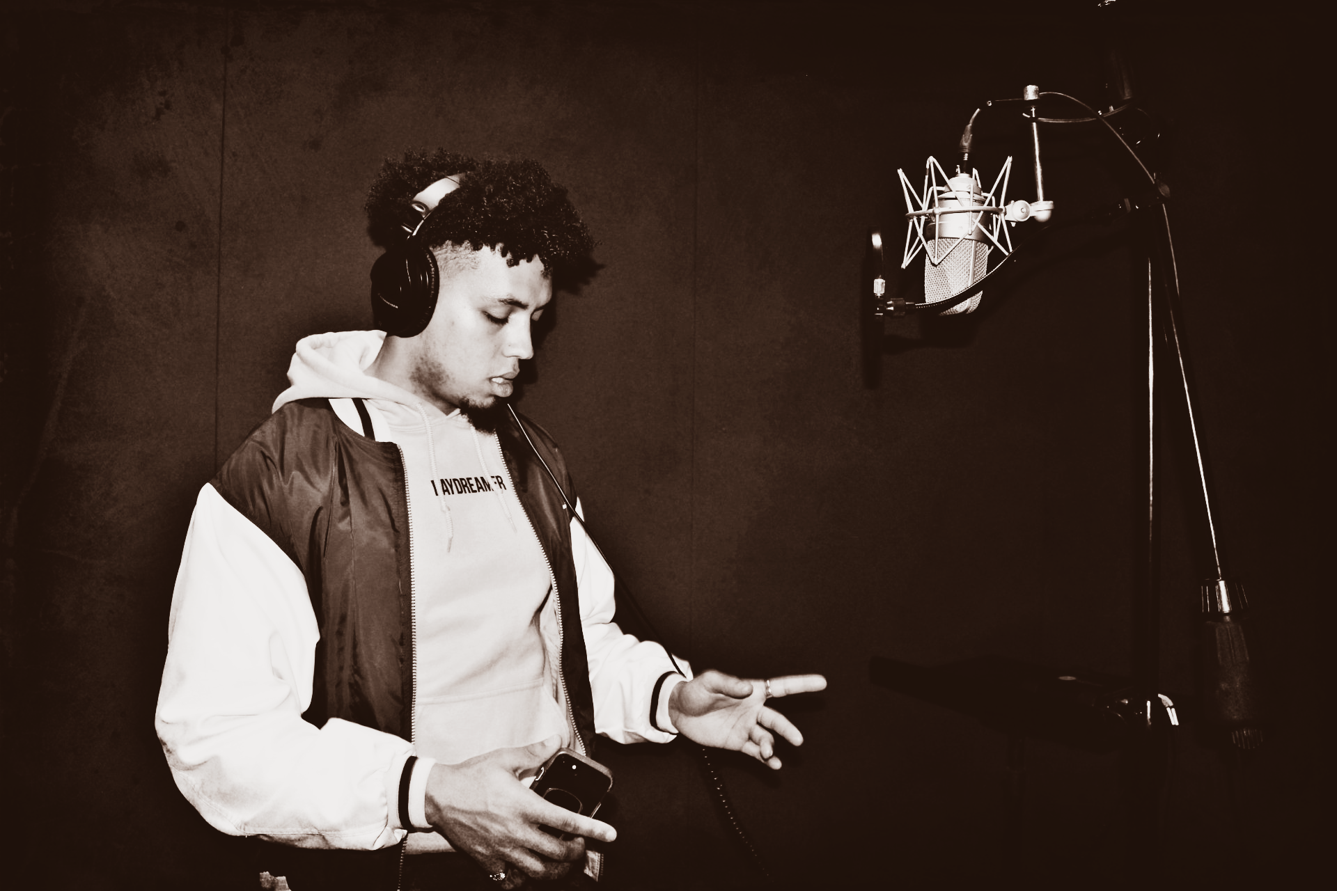 boy in headphones rapping down a mic