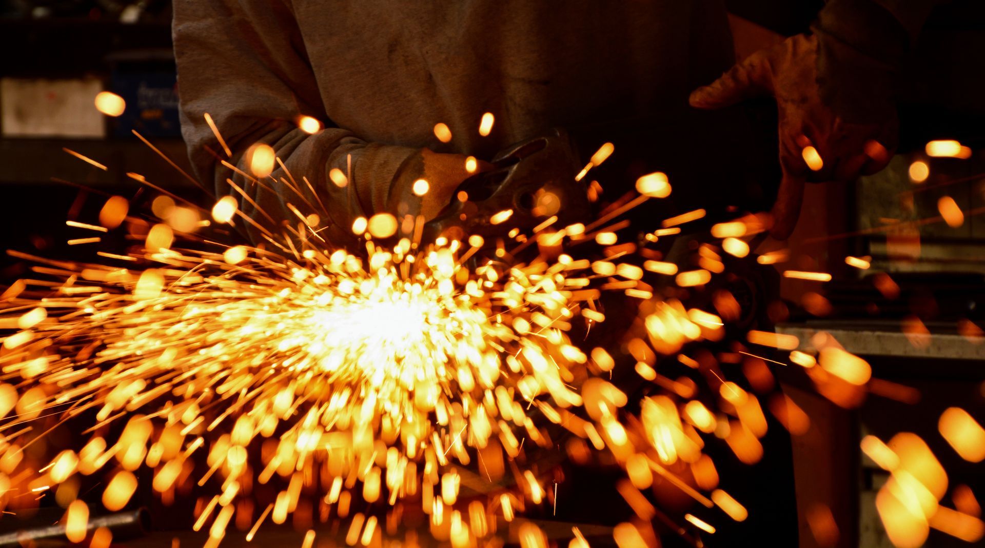 Close-up of welding with bright sparks and swirling blue smoke. Close-up of welding with bright sparks and swirling blue smoke.