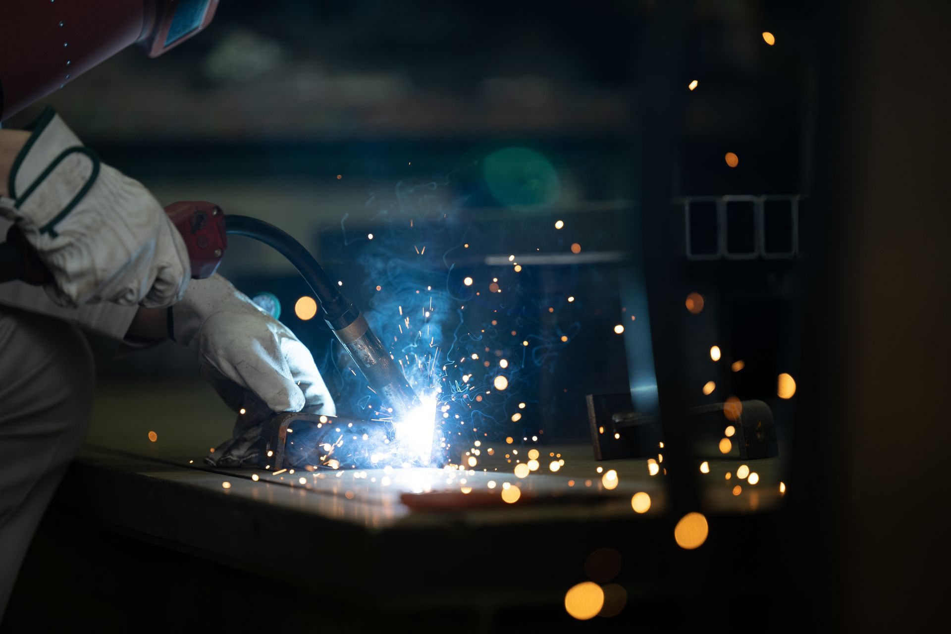 Close-up of welding sparks during residential ironworks fabrication.