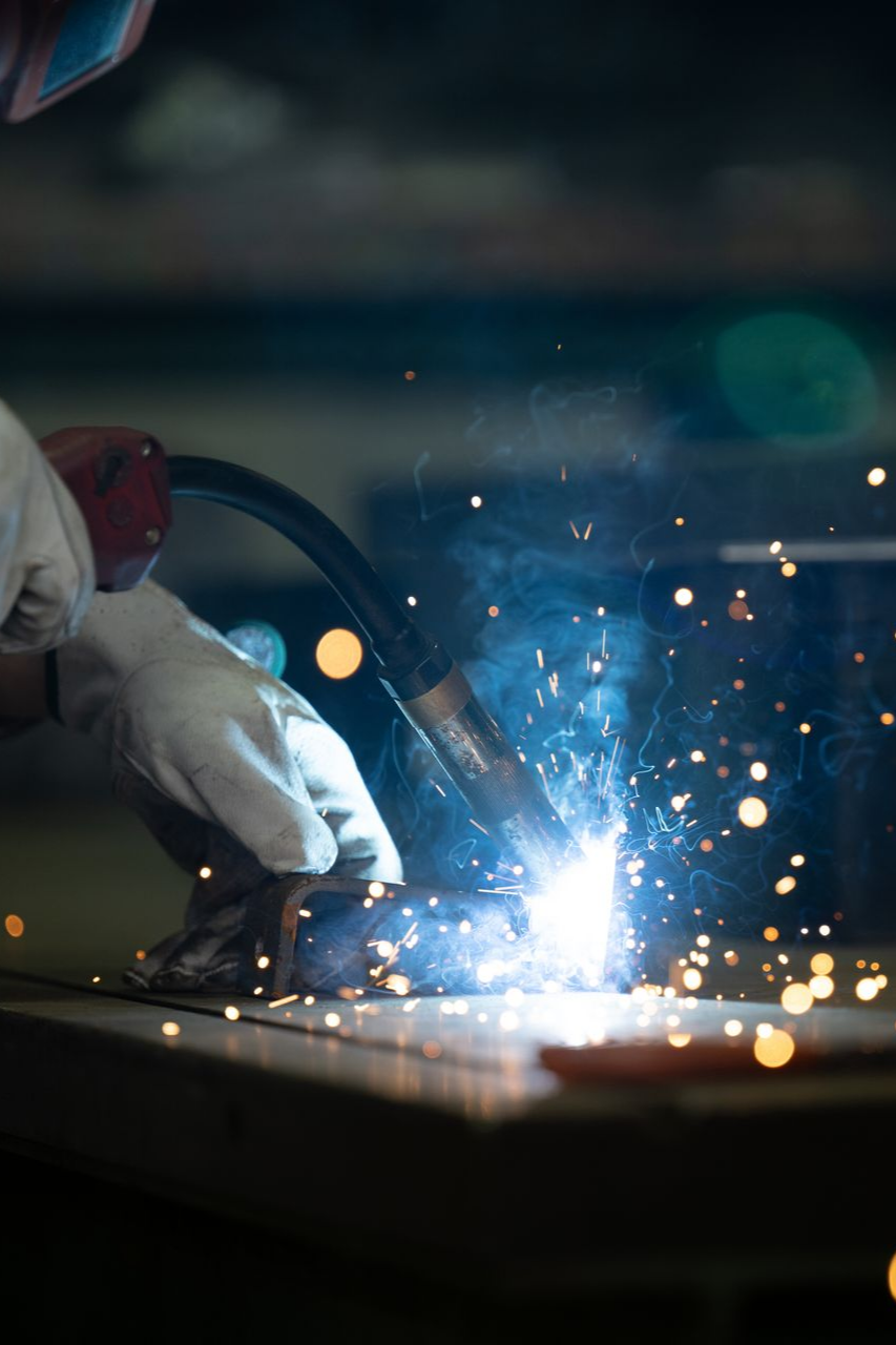 Close-up of welding sparks during residential ironworks fabrication.