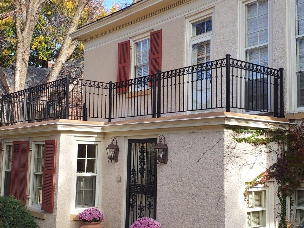 A house with a balcony and a wrought iron railing