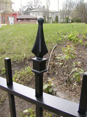 A black wrought iron fence with a pointed top