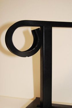 A black metal sculpture with the letter o on it