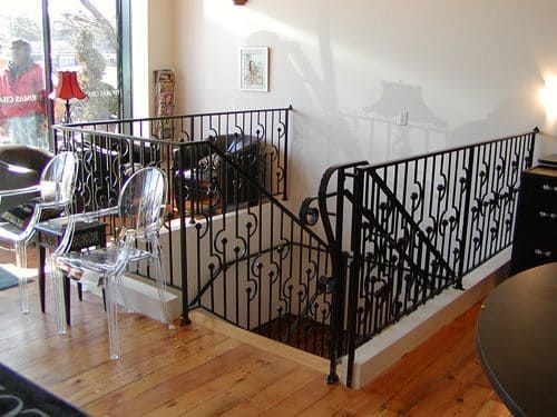 A staircase with a wrought iron railing in a living room
