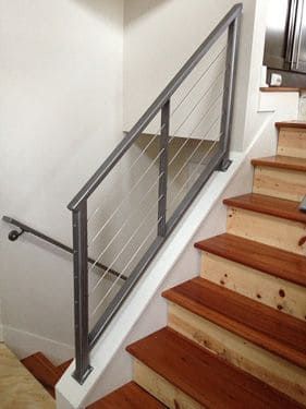 A staircase with wooden steps and a metal railing.
