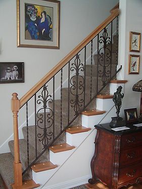 A staircase with a wrought iron railing in a living room