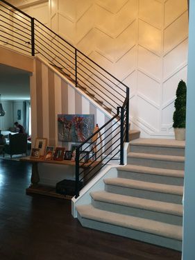 A staircase in a house with a black railing