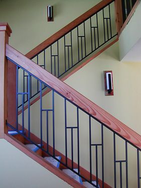 A staircase with a wooden railing and a metal railing