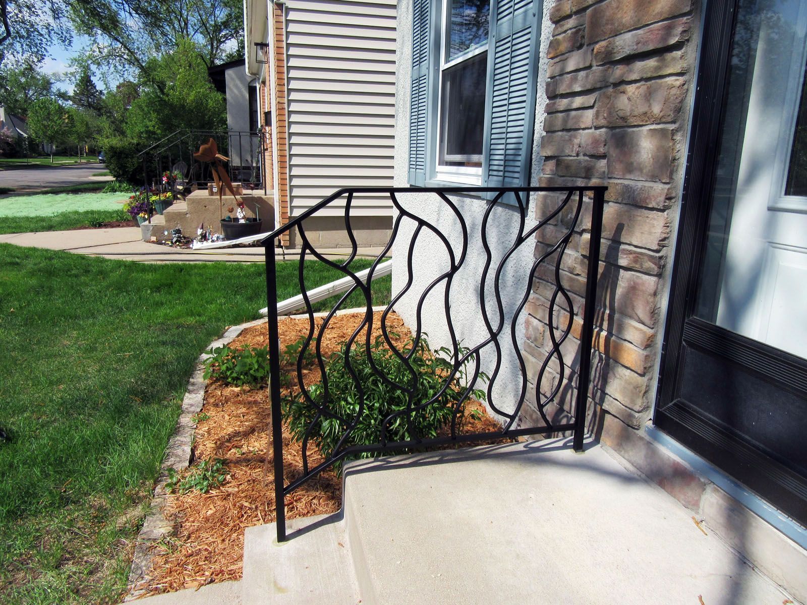 A wrought iron railing on the side of a house