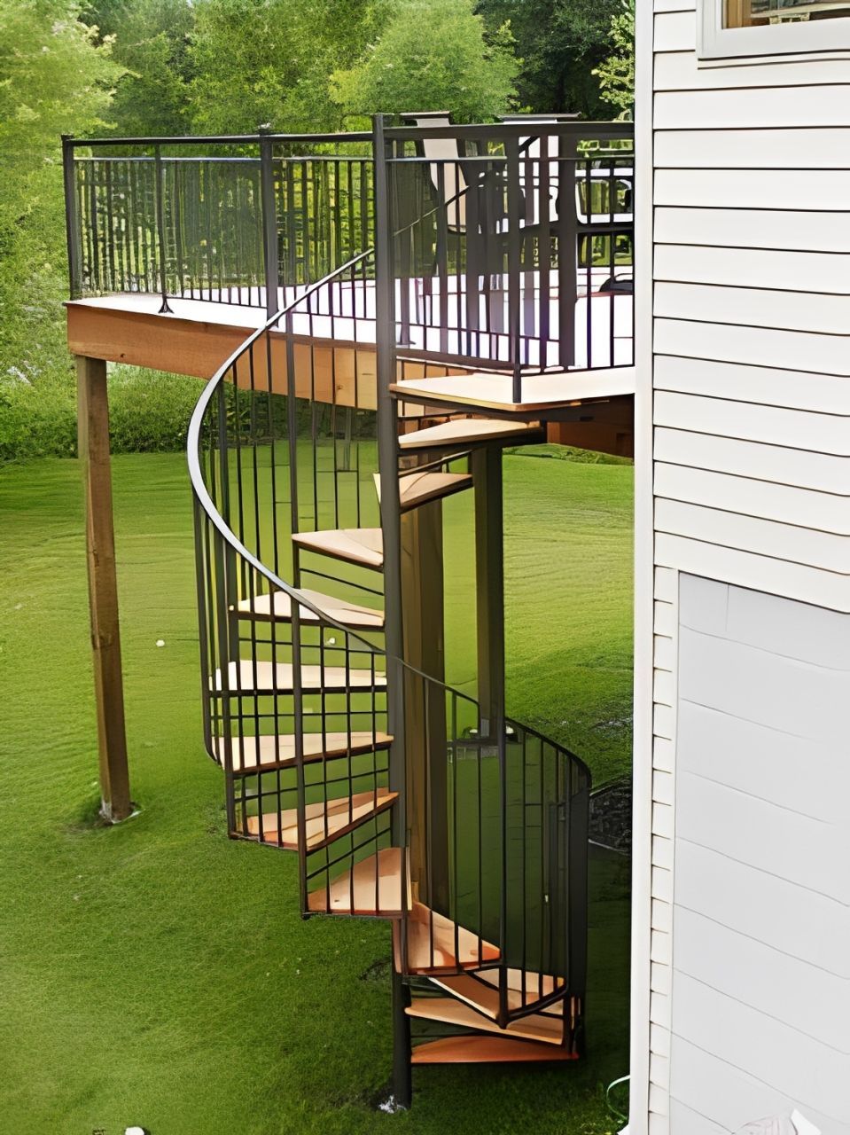 A black exterior spiral staircase with wood treads.