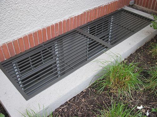 A window well with a metal grille on it