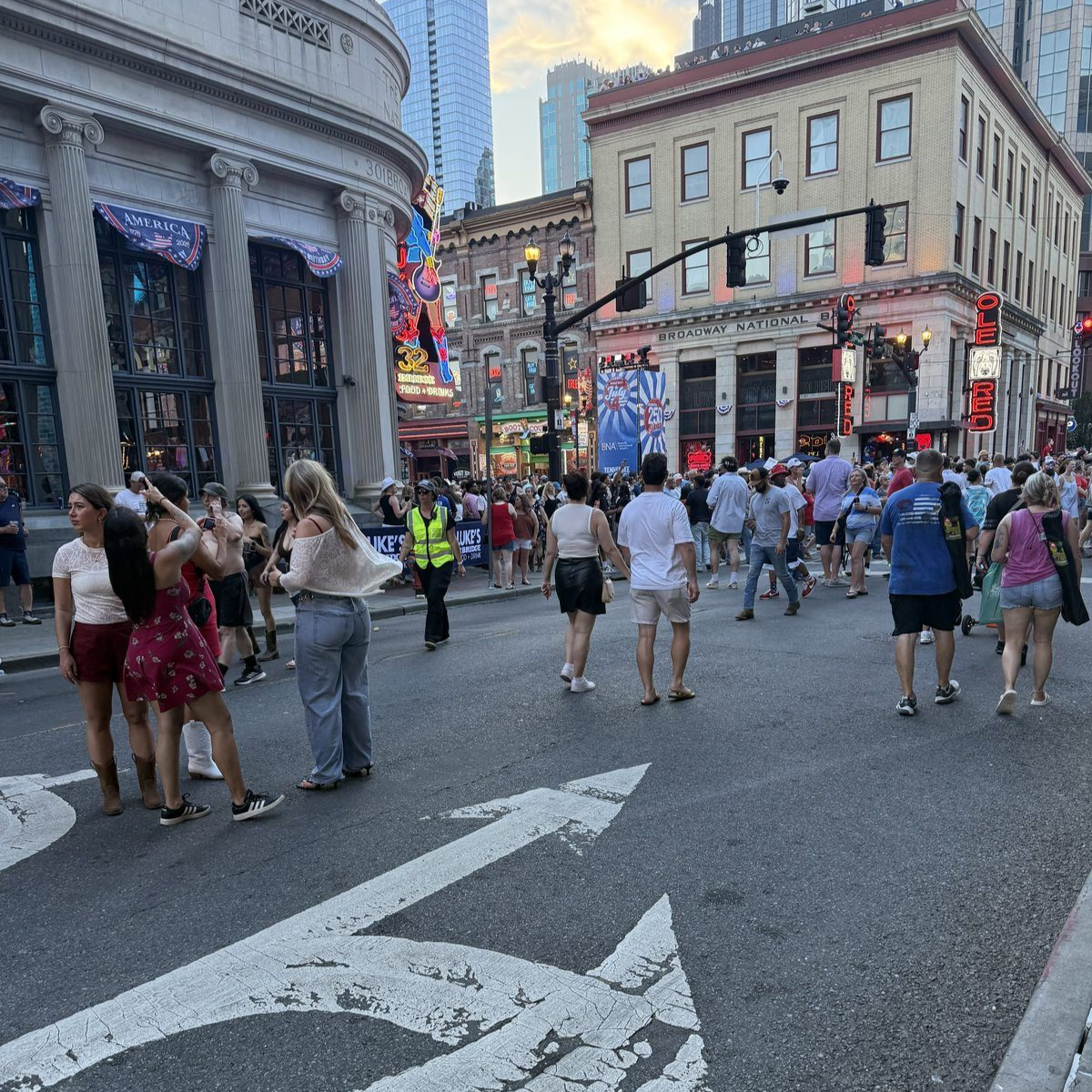 Crowds fill Lower Broadway in Nashville on July 4th as neon honky-tonk signs compete for attention