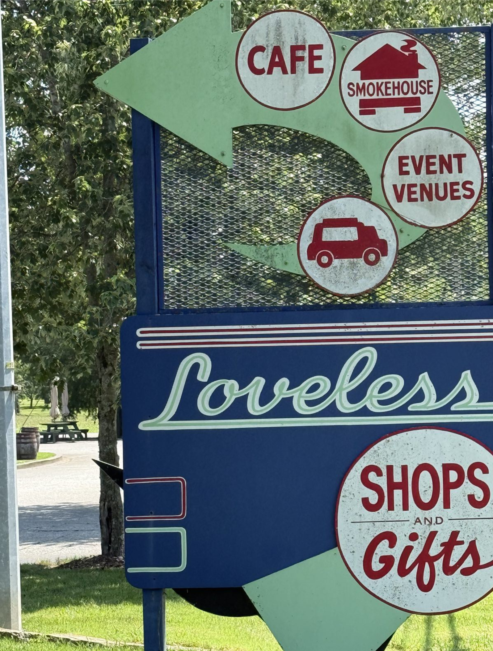 Loveless Cafe roadside sign pointing to the cafe, smokehouse, and shops