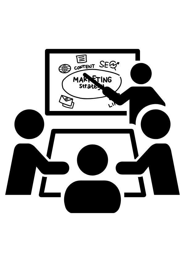 A group of people are sitting around a table and a man is giving a presentation.