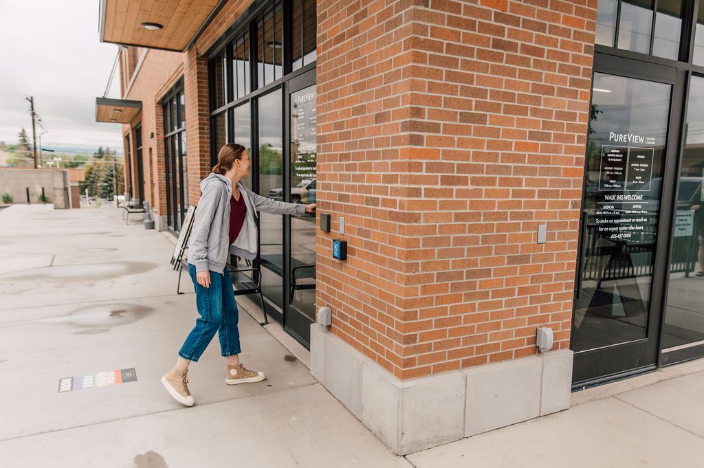A woman is walking into PureView Health Center