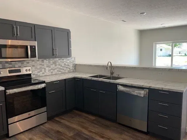 Stainless Steel Appliances And Gray Cabinets — Sioux City, IA — Construction Plus LLC