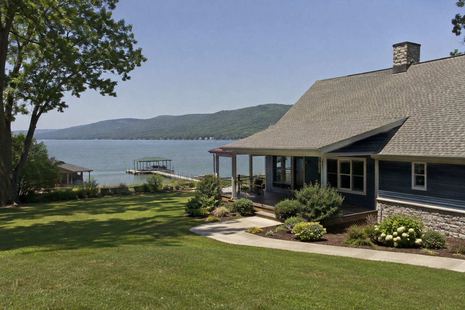 Daylight view of a house near Lake Guntersville with calm water in the background.