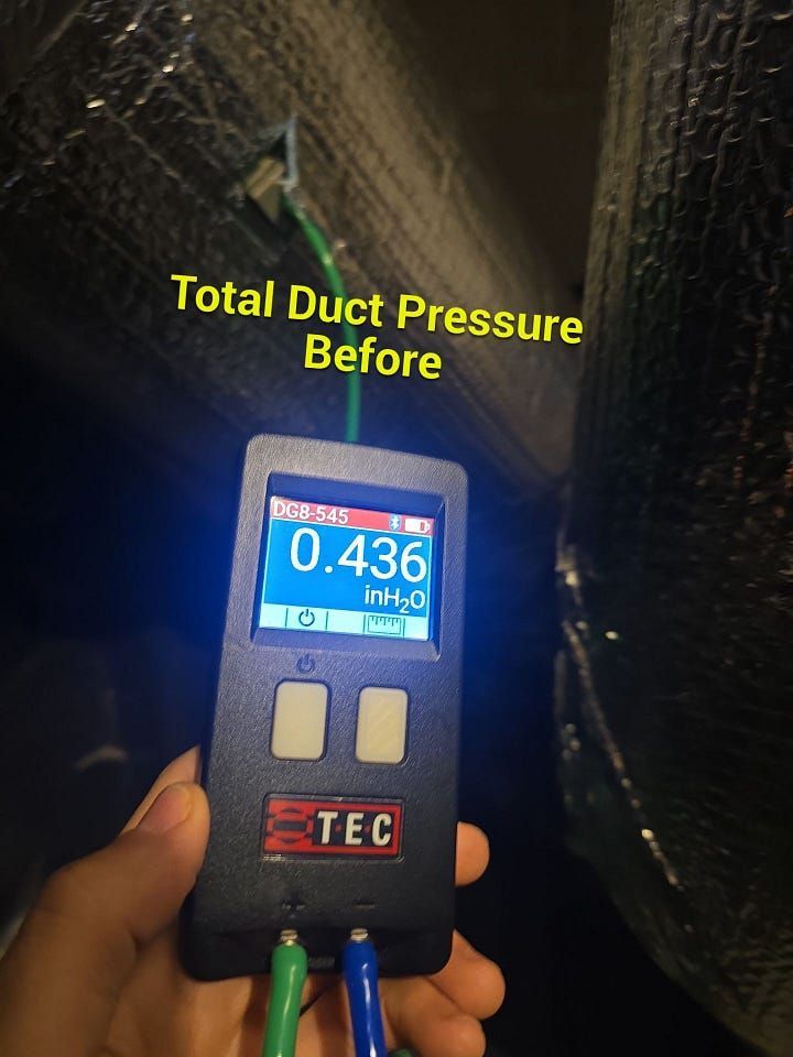 Handheld duct pressure meter reading 0.436 in black insulated ducting, labeled “Total Duct Pressure Before”