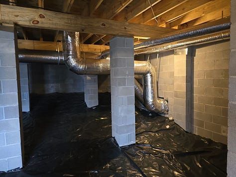 Crawlspace with exposed ductwork, cinder block columns, and black vapor barrier under wooden floor joists