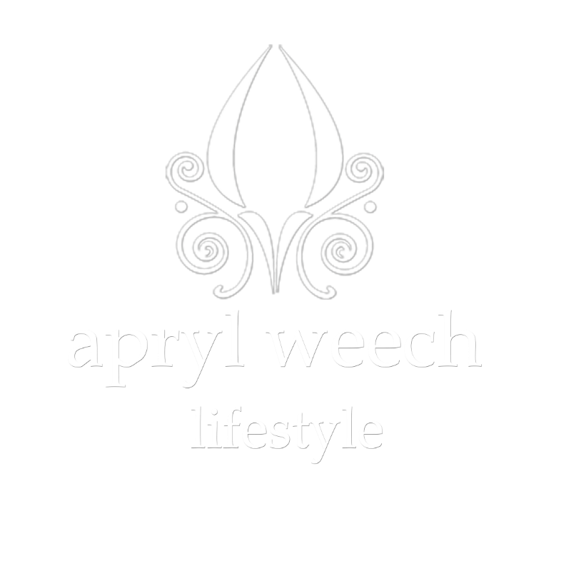 A black and white logo for ayurvedic lifestyle with a flower and swirls.