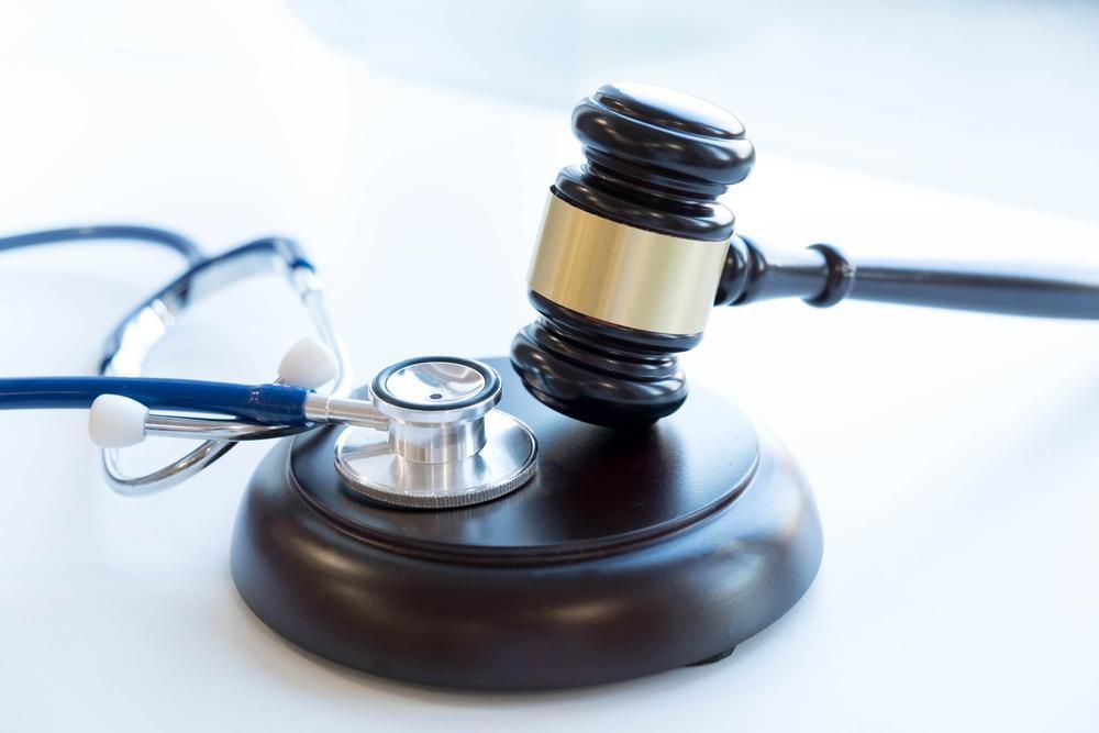 A Judge's Gavel and Stethoscope Are on a Table — Tony Love Lawyers in Gold Coast, QLD
