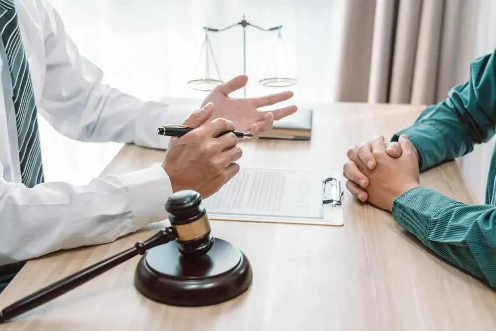 Lawyer in a White Shirt and Tie Explains Documents to a Client — Tony Love Lawyers in Lismore, NSW