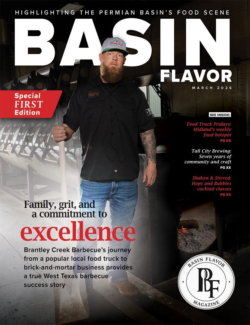 Magazine cover featuring a man in a black shirt and jeans standing in a kitchen above the text, 