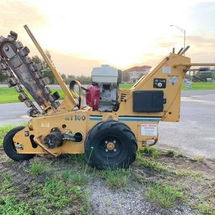 A yellow trencher is parked on the side of the road.
