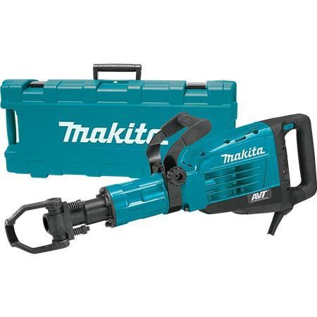 A makita demolition hammer is sitting next to a makita case.
