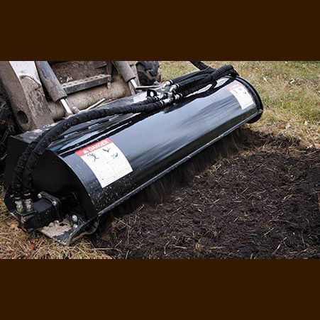 A black machine is sitting on top of a pile of dirt.