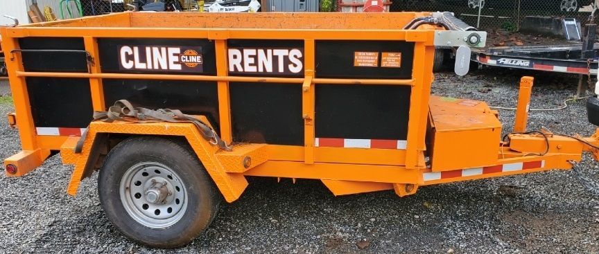 An orange trailer with the words cline rents on it