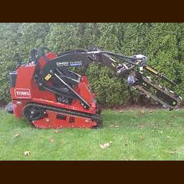 A red tractor is sitting on top of a lush green lawn.