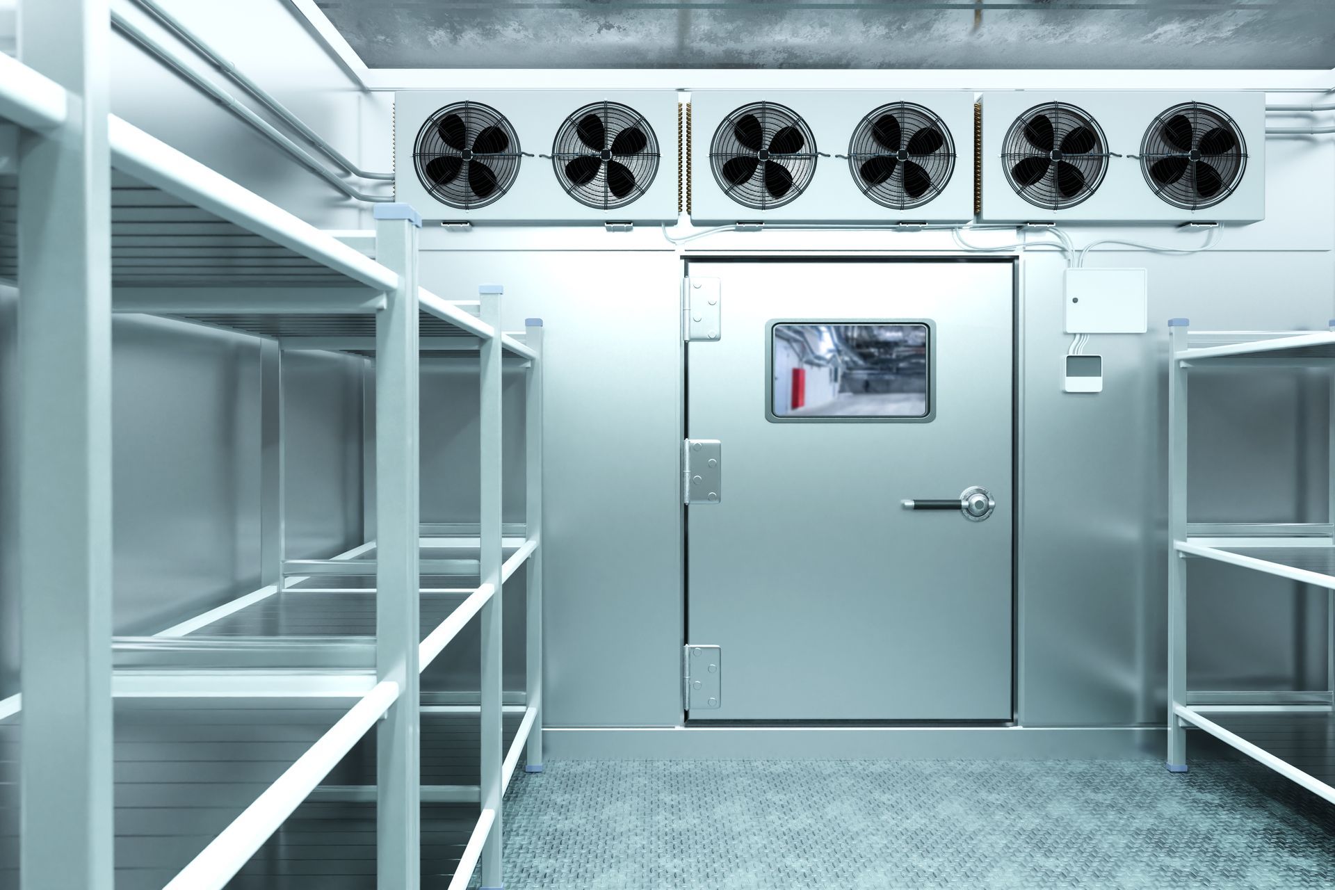 Sterile walk-in cooler with metal shelves, fans overhead, and a closed door at the end. Sterile walk-in cooler with metal shelves, fans overhead, and a closed door at the end.