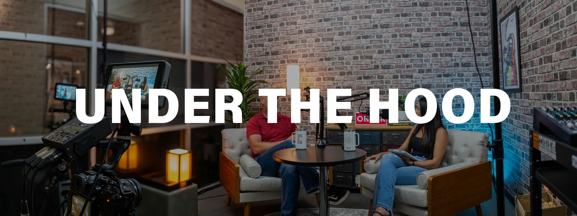 A man and a woman are sitting at a table in a living room.