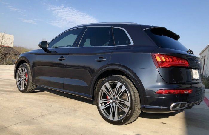 A black audi q5 is parked in a parking lot.